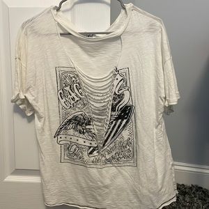 oversized, distressed white tee says “eagle” and “live to ride ride to live”
